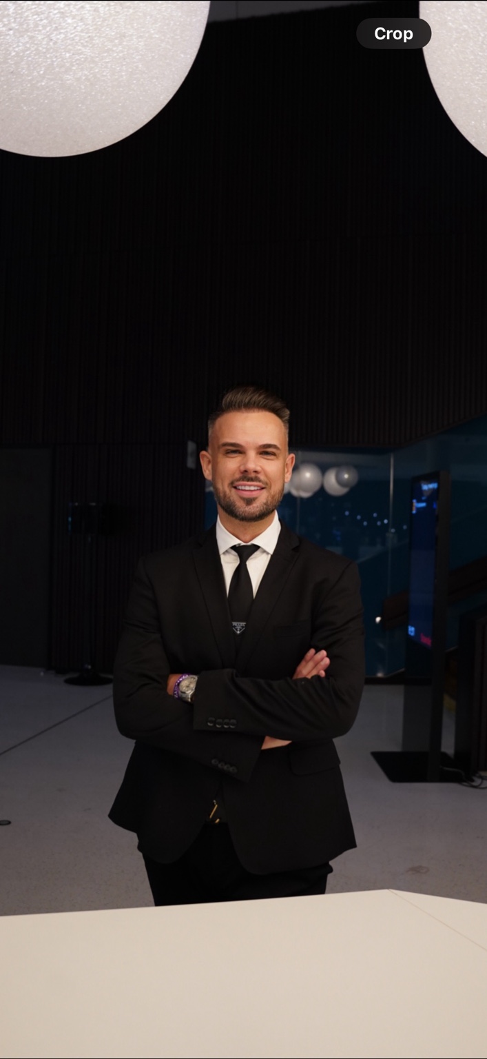 Ivan Martinec in a black suit, with his arms crossed